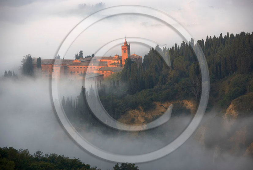 2006 - View of Mount Oliveto Abbay with fog in early morning, near Chiusure village, Crete Senesi land, 22 miles south the province of Siena.