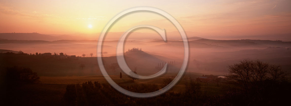 2001 - Panoramic view of farm and cipress with fog on sunrise in winter, near S.Quirico village, Orcia valley, 21 miles south the province of Siena.