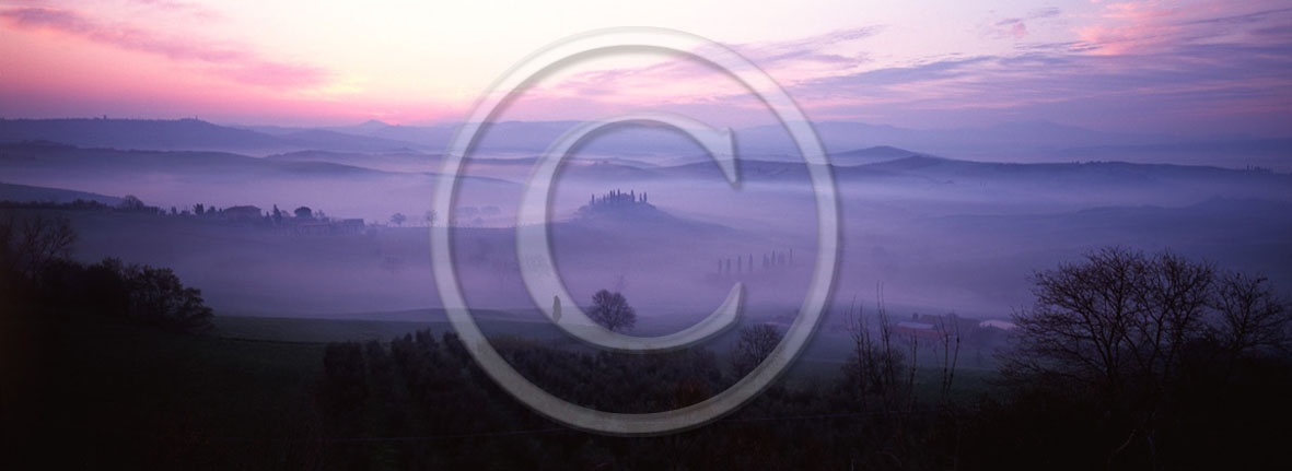 2001 - Panoramic view of farm and cipress with fog a bit before sunrise in winter, near S.Quirico village, Orcia valley, 21 miles south the province of Siena.