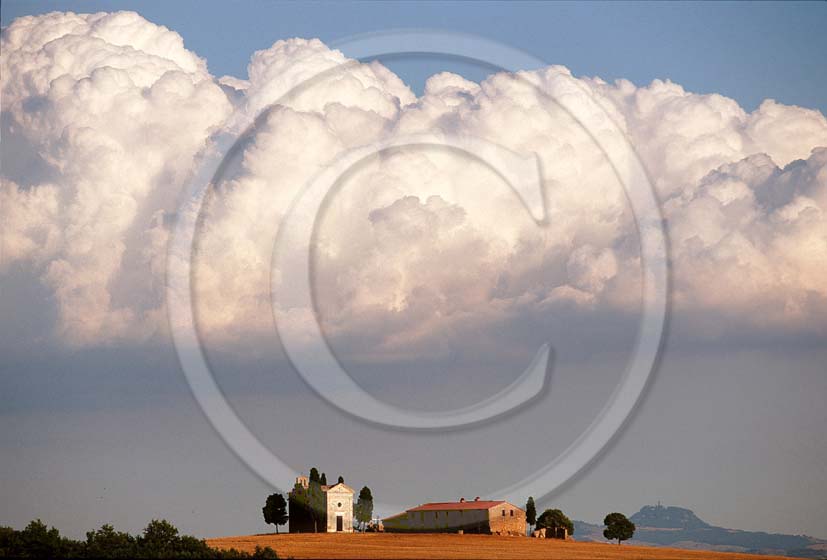 2002 - Landscapes of church and farm with white clouds in summer, near Pienza village, Orcia valley, 20 miles south the province of Siena.