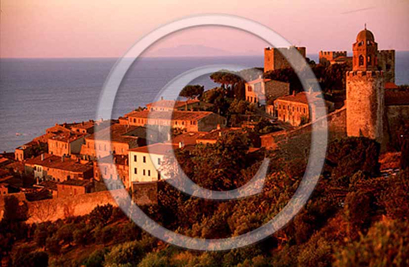 1994 - View of Castiglione della Pescaia medieval village on sunrise.