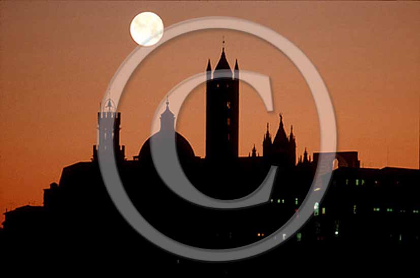 1990 - View of Siena town on sunset with moon.