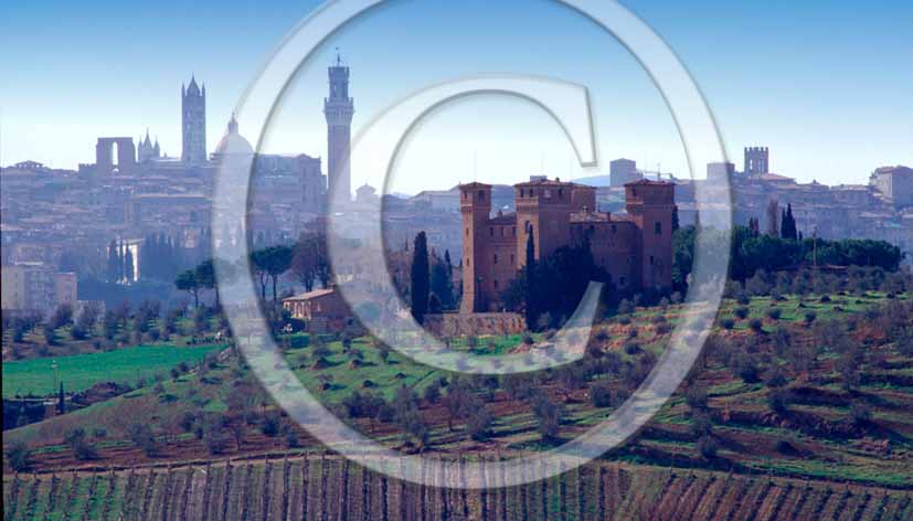 1988 - View of Four Tower castel in countryside within background Siena town.