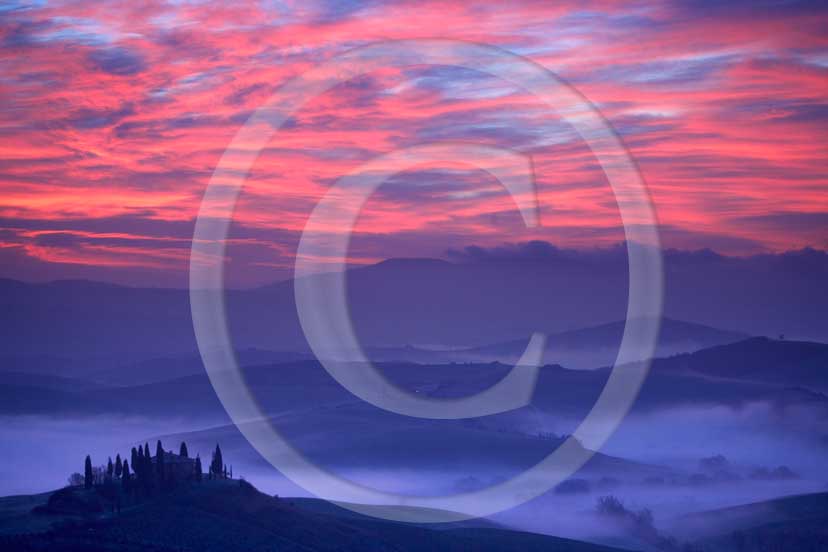 2007 - Landscapes of farm and cipress with fog and red orange sky a bit before sunrise in spring, near S.Quirico village, Orcia valley 21 miles south province of Siena.