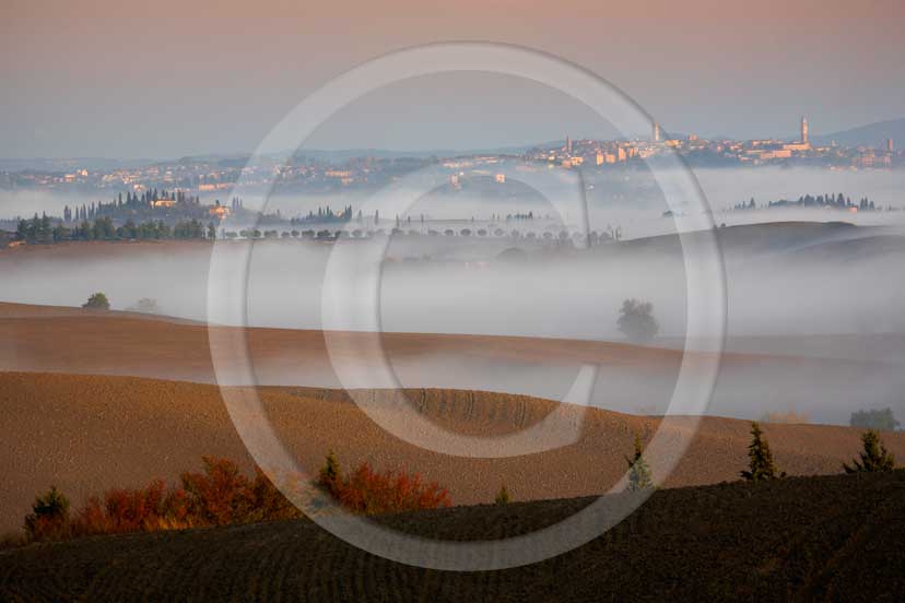 2007 - Landscapes with fog and Siena town in background on sunrise in autumn, near Ville di Corsano place, Crete Senesi land, 14 miles est Siena province. 