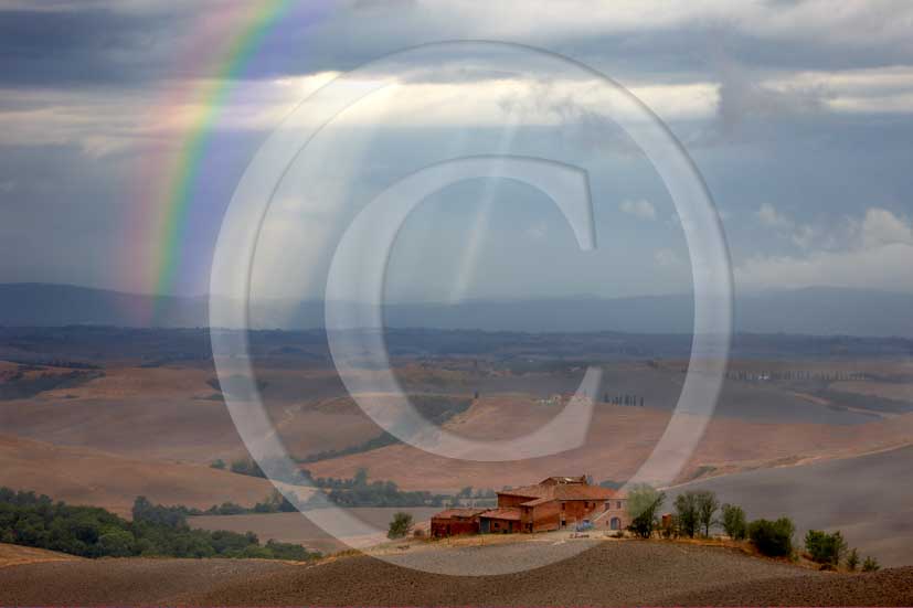 2008 - Landscapes with farm before a thunderstorm with rainbow on summer in Crete senesi land, near Taverne Arbia village, Mucigliani place, 15 miles south the province of Siena.