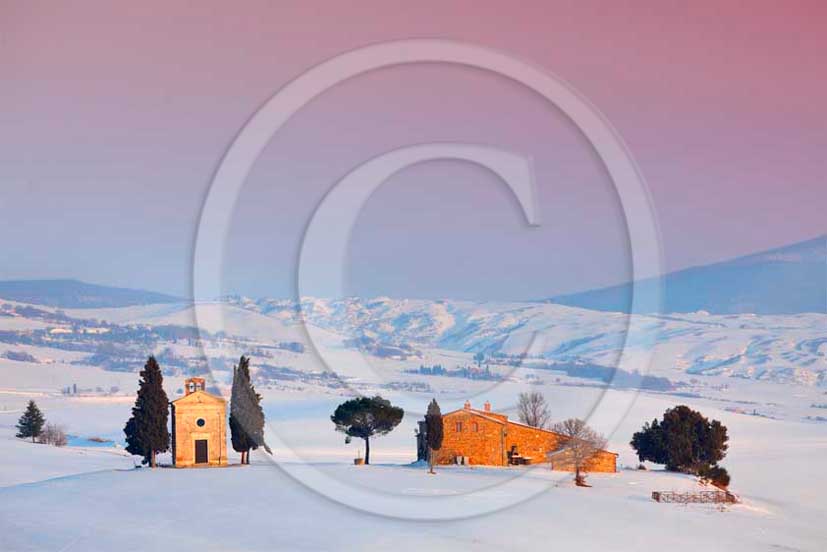 2012 - View of farm, cypress line with snow in winter in Orcia valley.