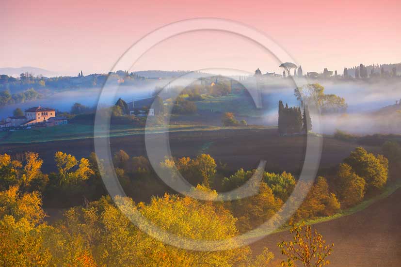 2012 - View on fog sunrise in autumn of the countryside near Siena in Crete Senesi land.