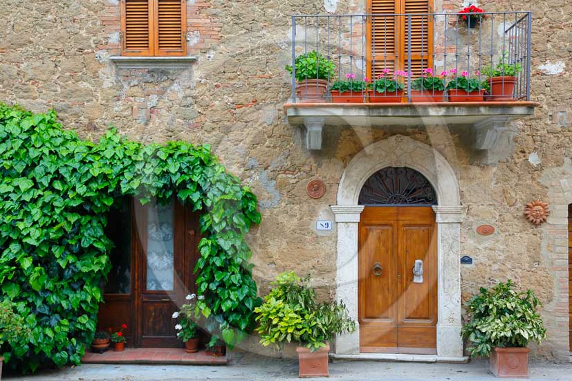 2013 - Traditional tuscan doors with red and yellow Gerani flowers.