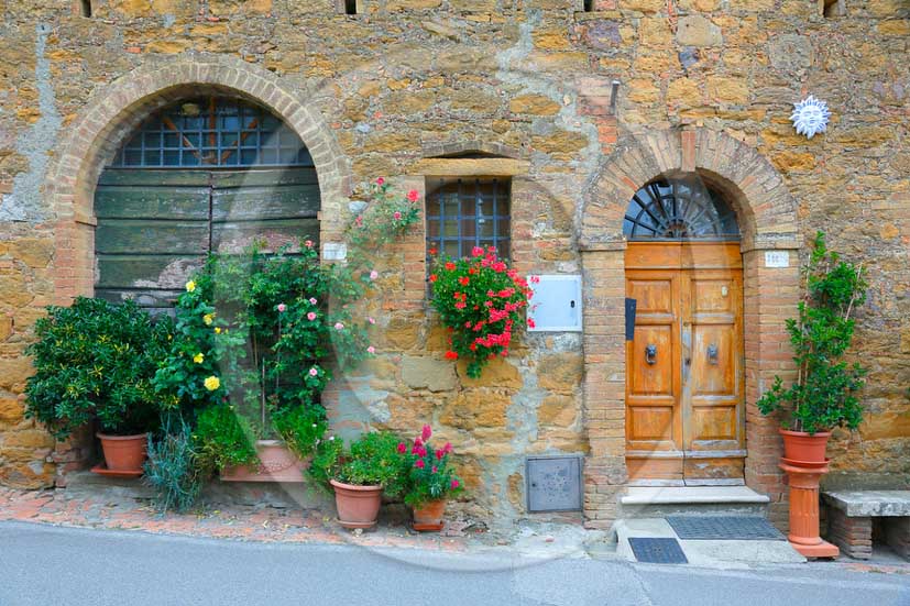 2013 - Traditional tuscan doors with red and yellow Gerani flowers.