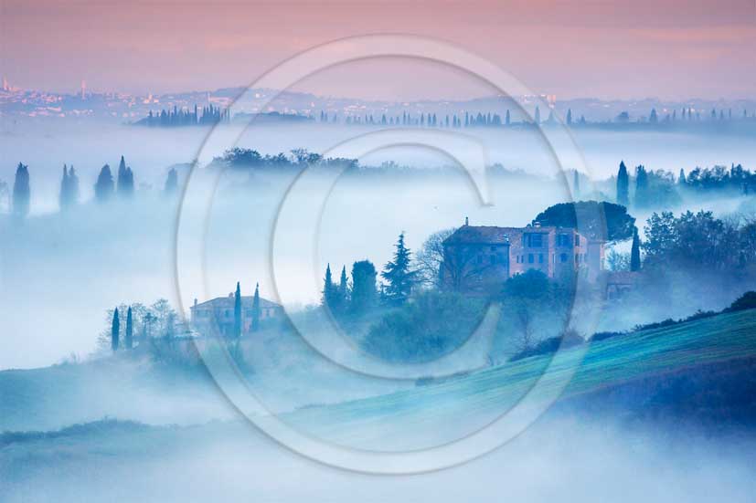 2013 - View of a fog early morning of the country and hills near san Giovanni D'Asso village in Crete Senesi land.