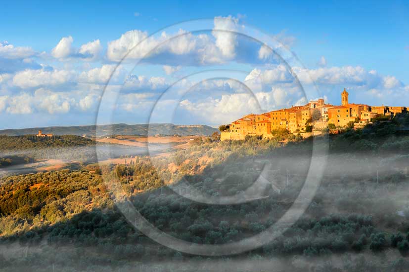 2013 - View at sunrise with fog of Castelmuzio village in Orcia valley.