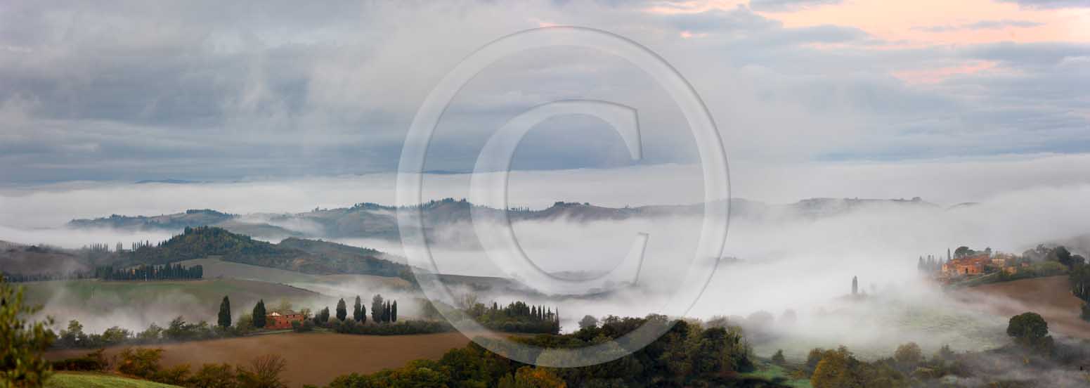 2008 - Panoramic view of landscapes and farm with fog on sunrise in
winter, Montemori place, near Asciano village, Crete Senesi land, 18
miles south province of Siena.<br />

  			
  			