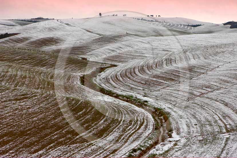 2009 - Landscapes of plowed field with snow in winter on
late afternoon, near S.Quirico village, Orcia valley, 15 miles south
the province of Siena.  			
  			