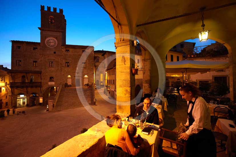   			2009 - People at restaurant in the main square of Cortona medieval village with the Council Palace on background, Val di Chiana valley, 21 miles east Arezzo province.  			
  			
  			