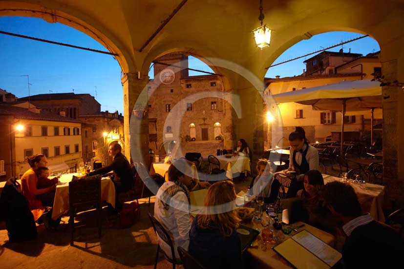   			2009 - People at restaurant in the main square of Cortona medieval village with the Council Palace on background, Val di Chiana valley, 21 miles east Arezzo province.  			
  			
  			