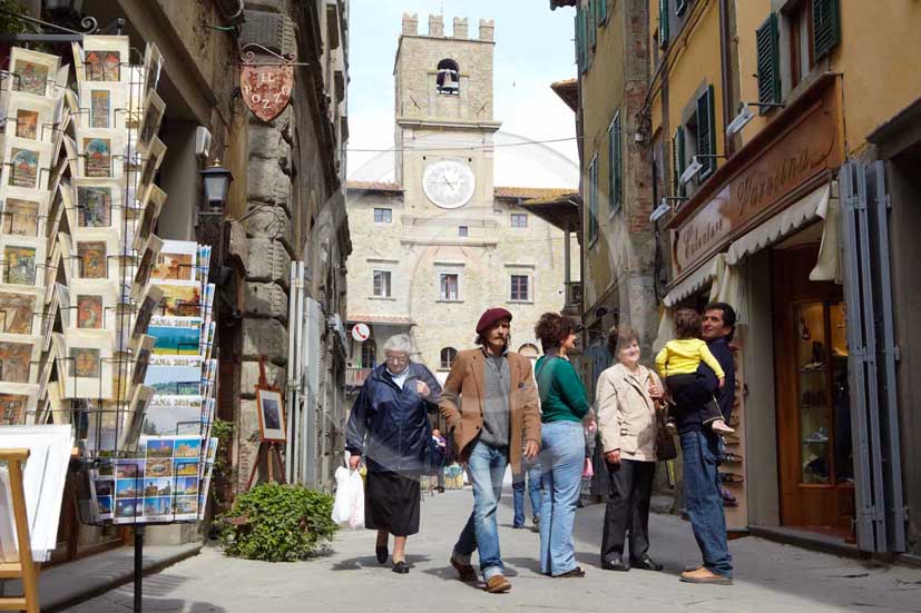 2009 - People walking in the main street of Cortona medieval village with the Council Palace on background, Val di Chiana valley, 21 miles east Arezzo province.  			
  			