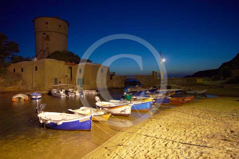 2009 - Night view of the beach, old fisher's boats and the tower of Campese of Isle of Giglio on summer, Maremma land, 80 miles south the province of Grosseto.