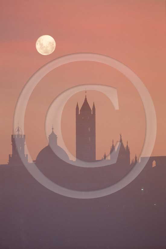 1986 - View of the Siena medieval village on sunrise with moon and fog with the main tower 