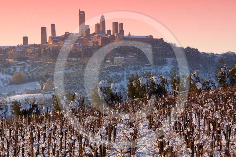   			2009 - Surrounding country viewer of San Gimignano medieval village with the main towers under the snow in winter on sunrise, Chianti land, 19 miles north Siena province.
  			